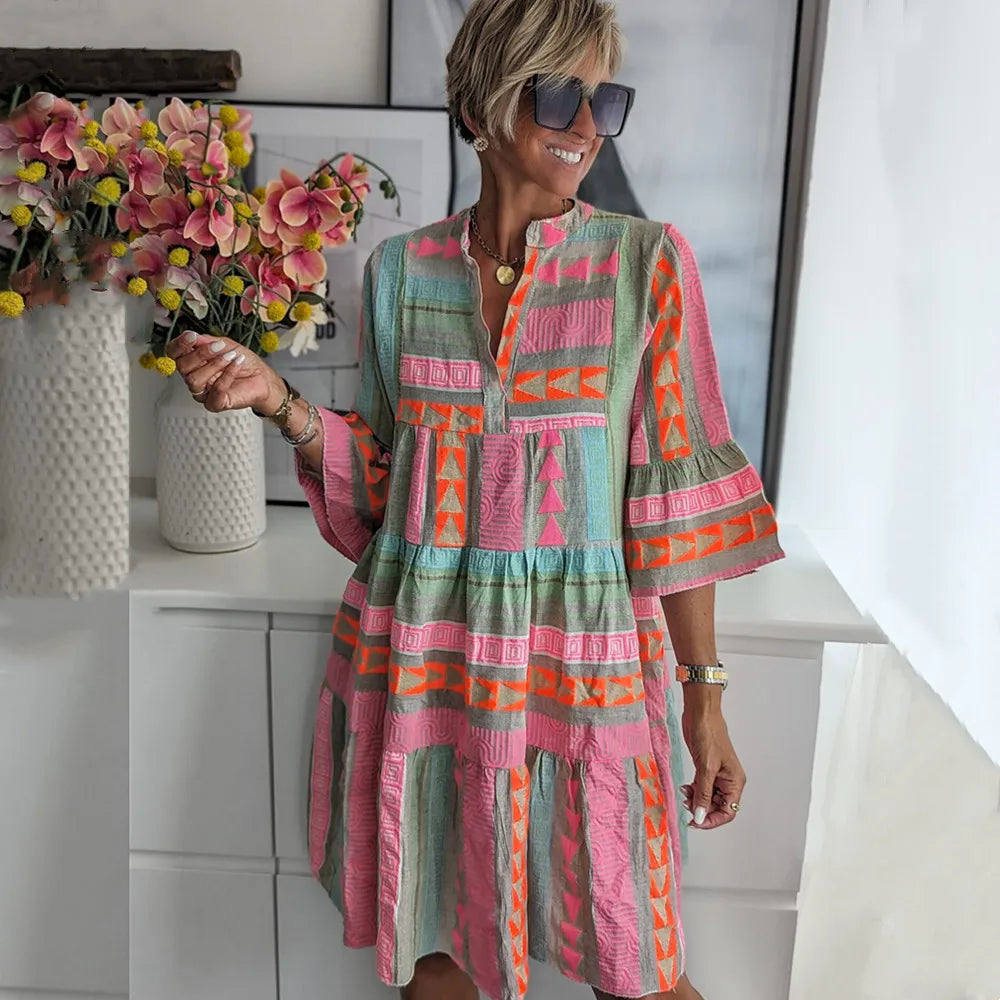 Woman wearing a flared spring mini dress with delicate ruffles and a V-neckline.