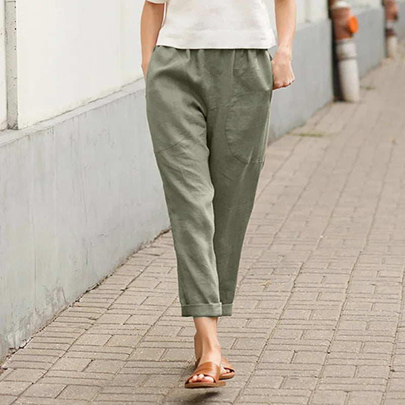 A woman wearing wide relaxed trousers with two roomy pockets and an elastic waist.