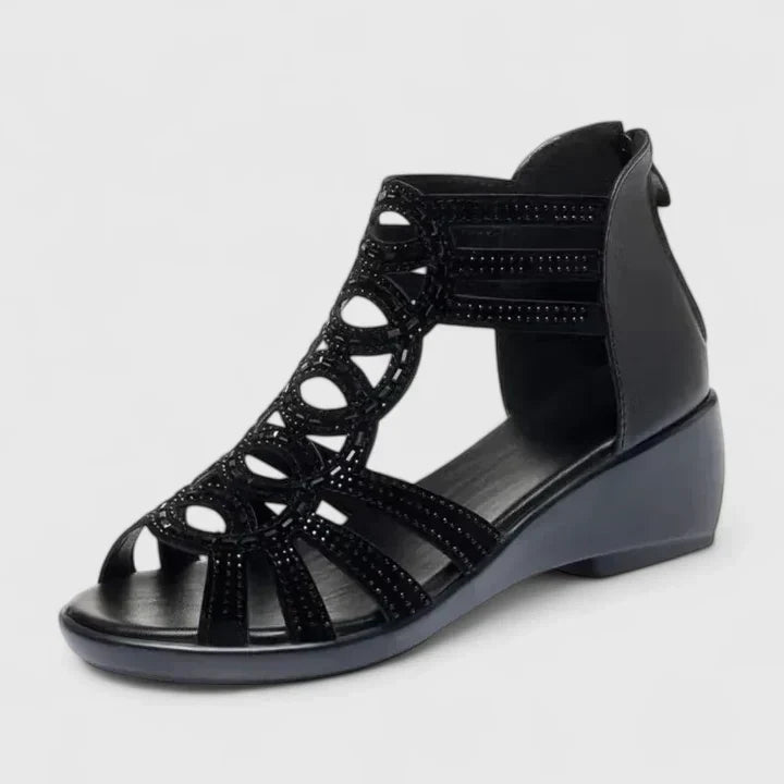 A woman's black caged wedge sandals with sparkle detail, an open toe and a back zip.