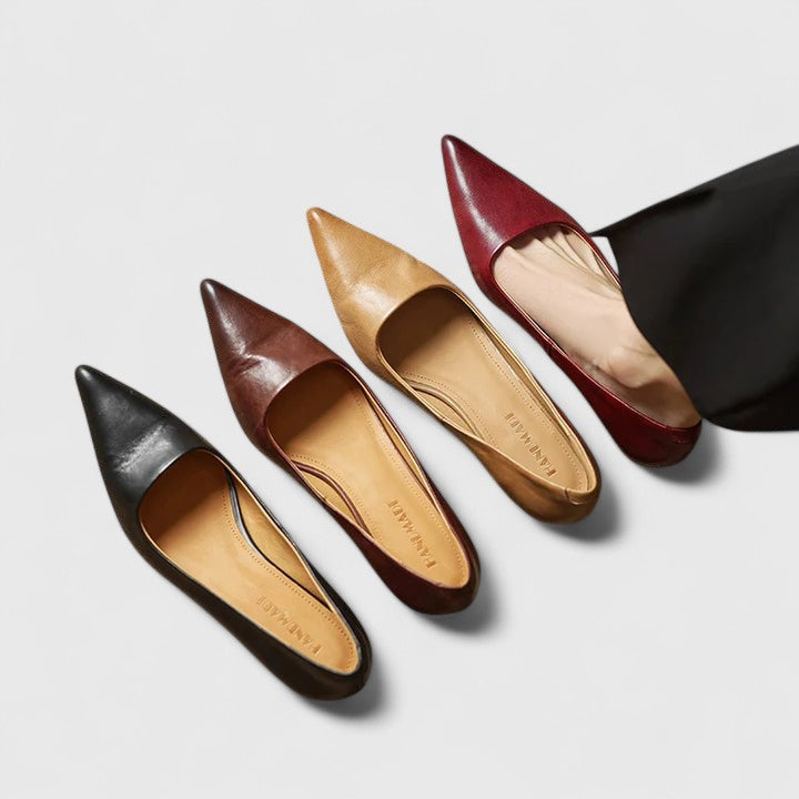 A woman in classic black pointed-toe comfort heels moving easily from office to evening.