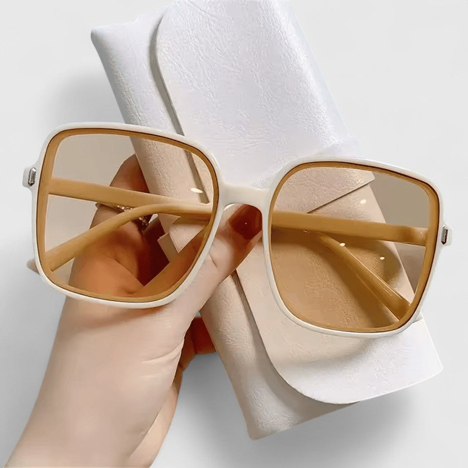 A woman running errands in town wearing classic square sunglasses, calm and stylish.