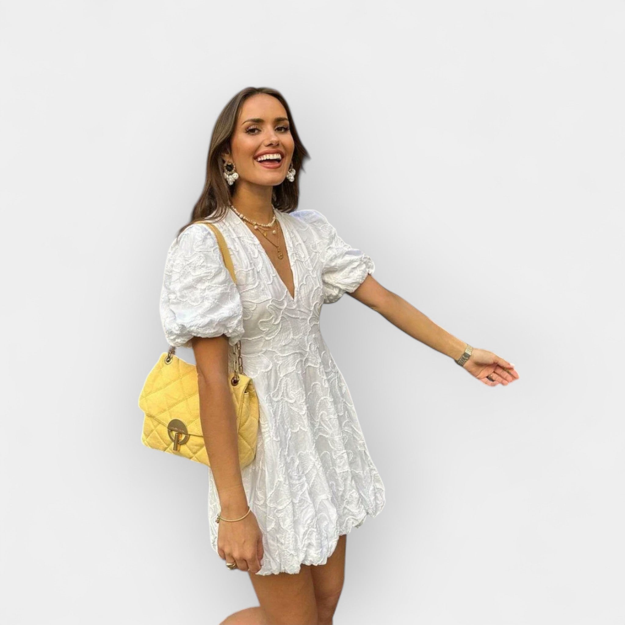 Flowing white summer dress with a soft romantic silhouette and gentle movement
