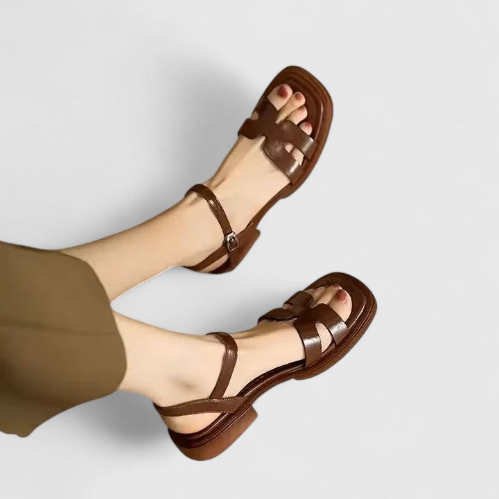 Minimalist sandals in white, black and brown with a wide front strap and adjustable ankle strap