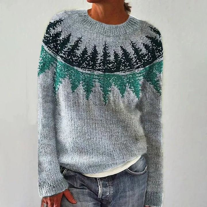 A woman wearing a colourful patterned hooded jumper, cosy and relaxed for autumn.