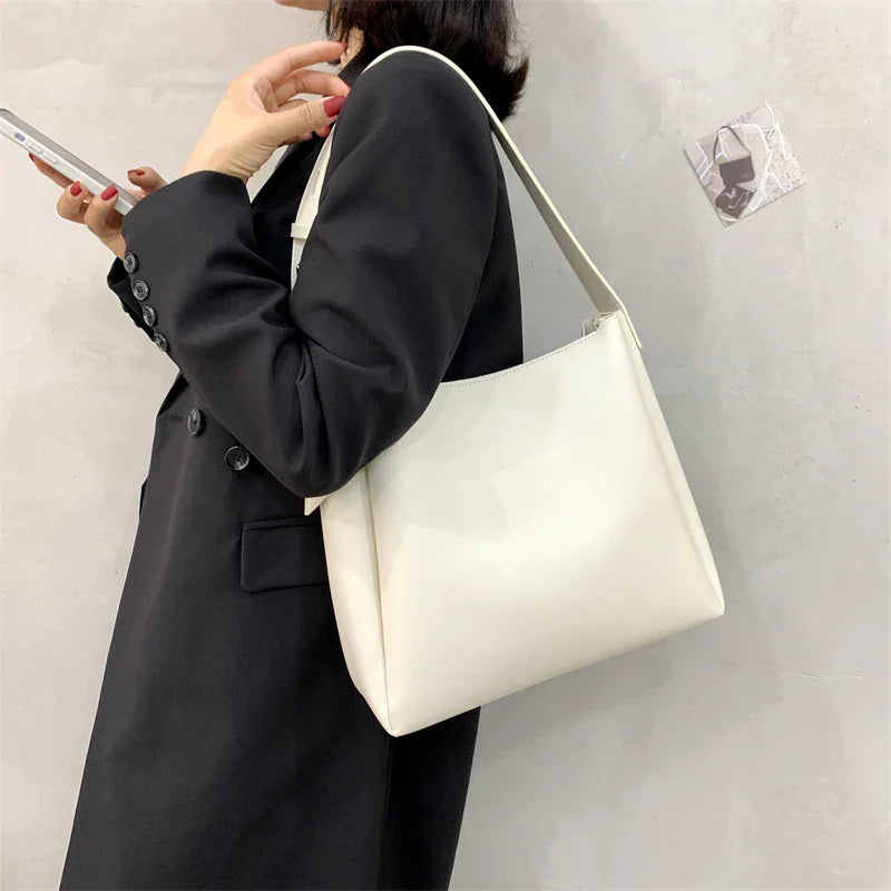 Elegant structured tote bag in black with clean minimalist lines and comfortable shoulder strap