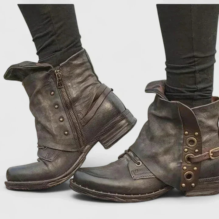 Woman wearing grey supportive ankle boots, walking confidently through town.