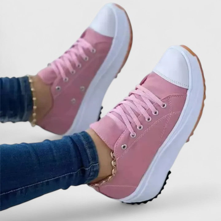 A woman in bold lace-up platform comfort trainers styled with jeans.