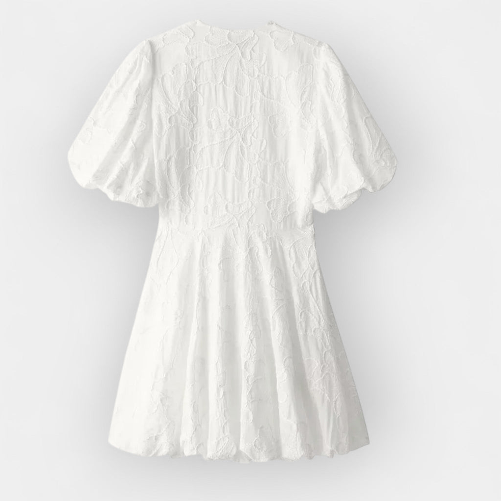 Flowing white summer dress with a soft romantic silhouette and gentle movement