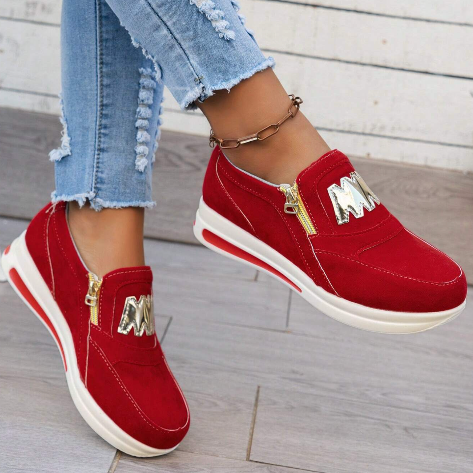 A woman wearing cushioned side-zip trainers with a relaxed everyday outfit