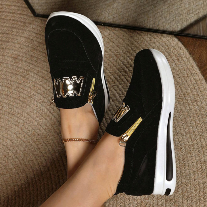 A woman wearing cushioned side-zip trainers with a relaxed everyday outfit