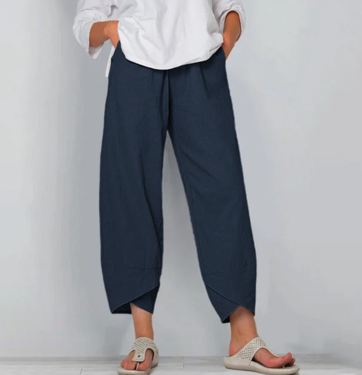 A woman wearing lightweight plain trousers with an elastic waist and handy pockets.