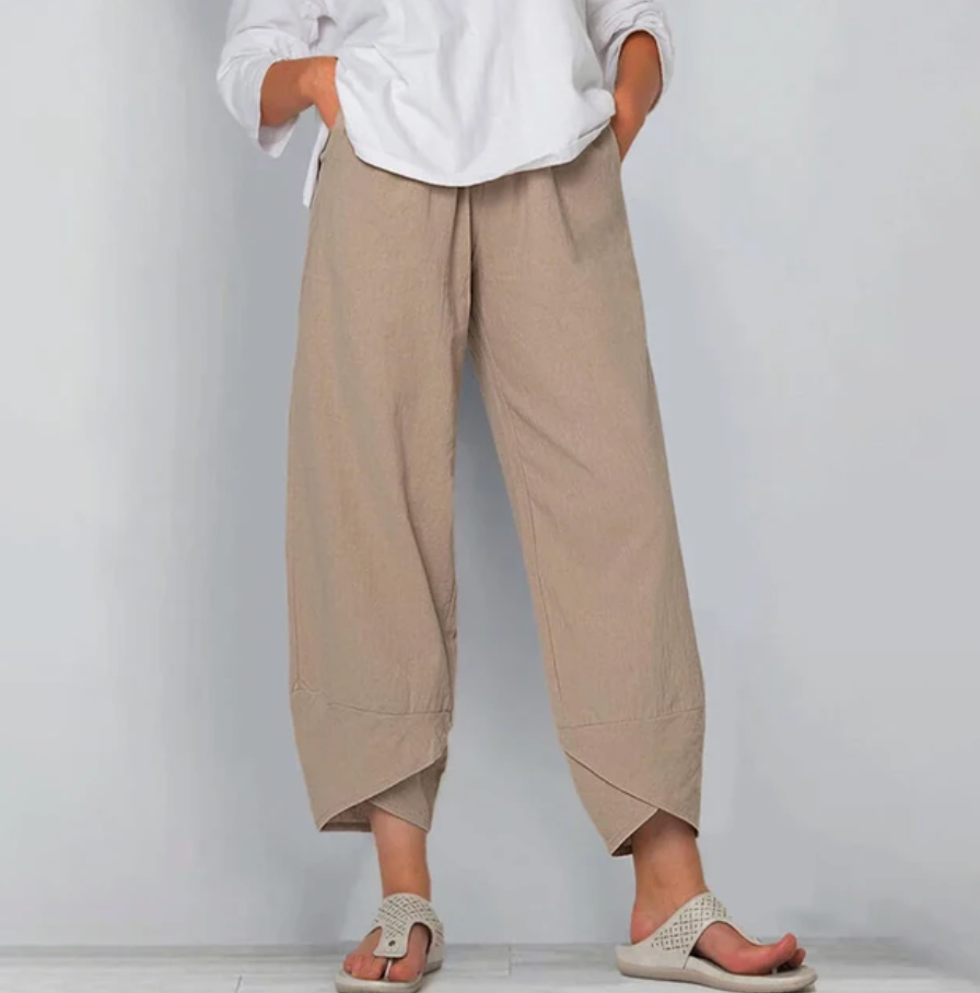 A woman wearing lightweight plain trousers with an elastic waist and handy pockets.