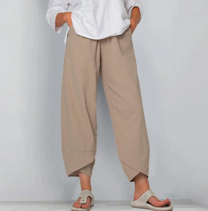 A woman wearing lightweight plain trousers with an elastic waist and handy pockets.