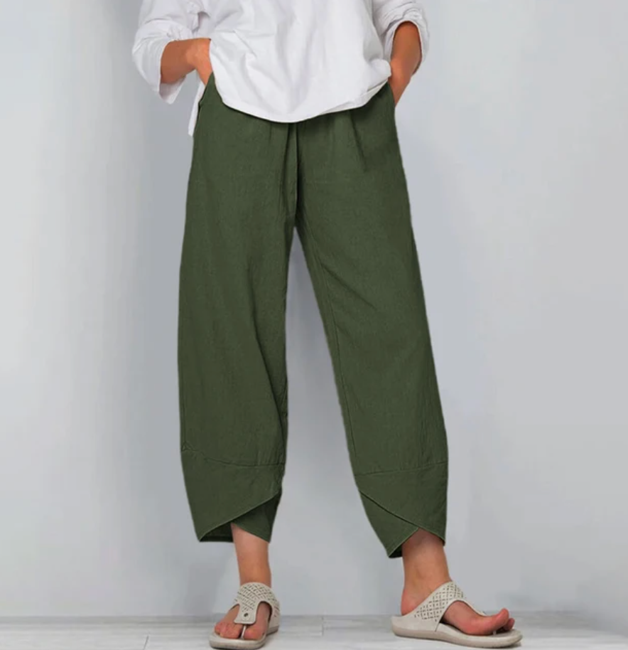 A woman wearing lightweight plain trousers with an elastic waist and handy pockets.