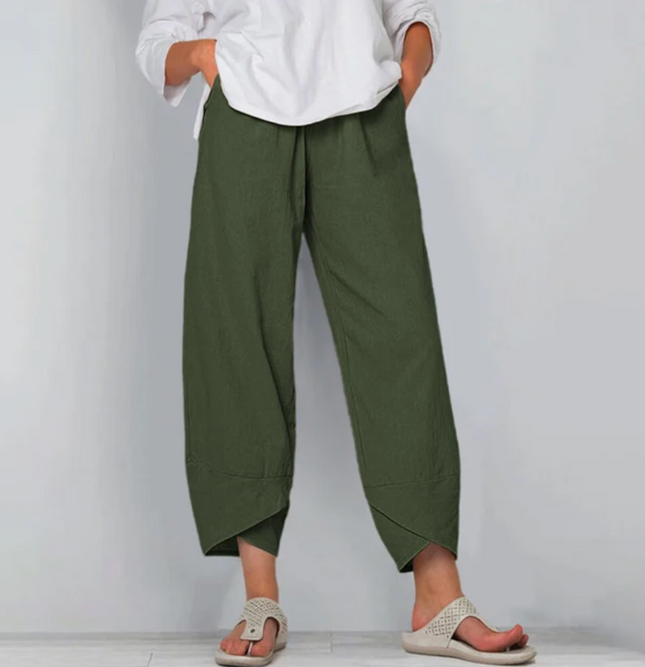 A woman wearing lightweight plain trousers with an elastic waist and handy pockets.