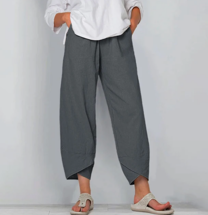 A woman wearing lightweight plain trousers with an elastic waist and handy pockets.
