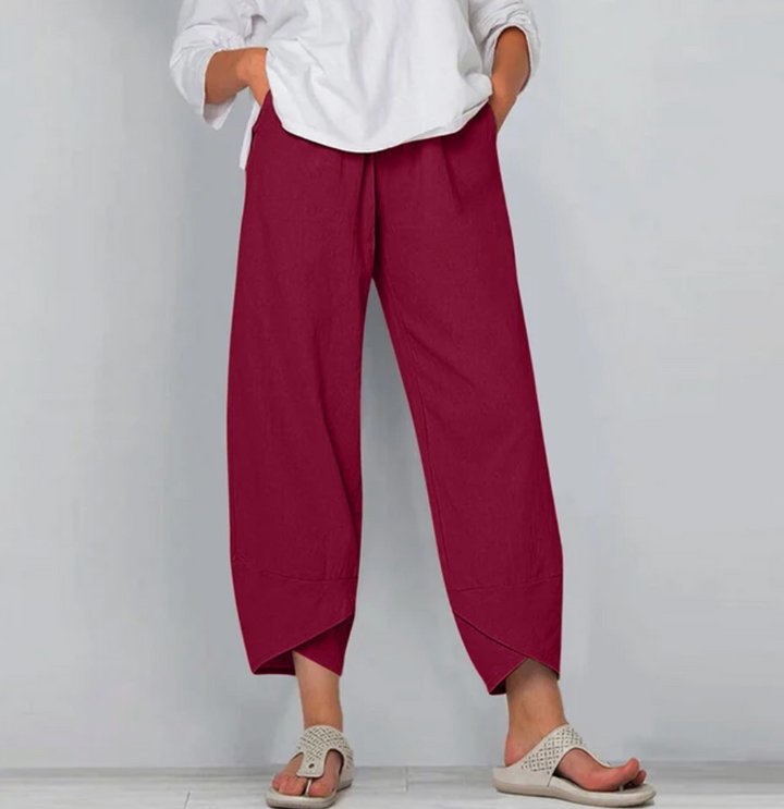 A woman wearing lightweight plain trousers with an elastic waist and handy pockets.