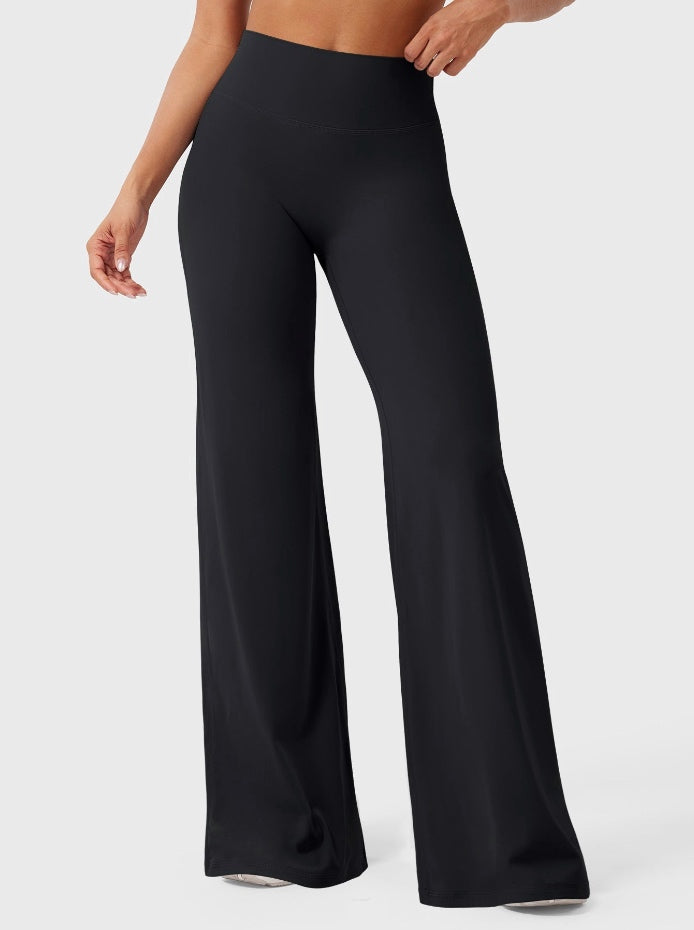 Black high-waisted power flare leggings with a contoured back seam and wide flared leg