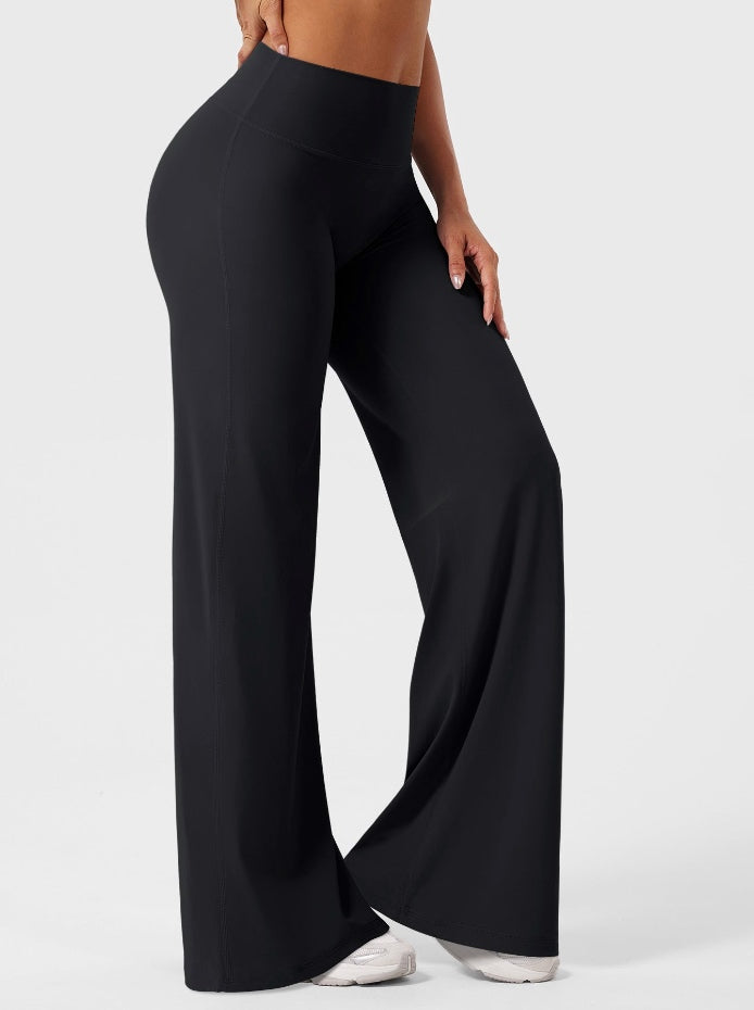 Black high-waisted power flare leggings with a contoured back seam and wide flared leg