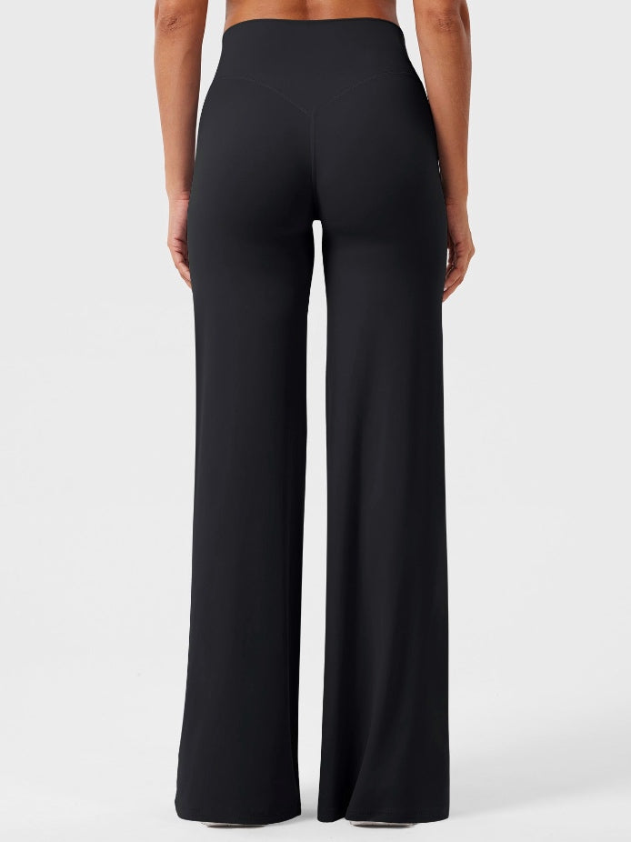 Black high-waisted power flare leggings with a contoured back seam and wide flared leg