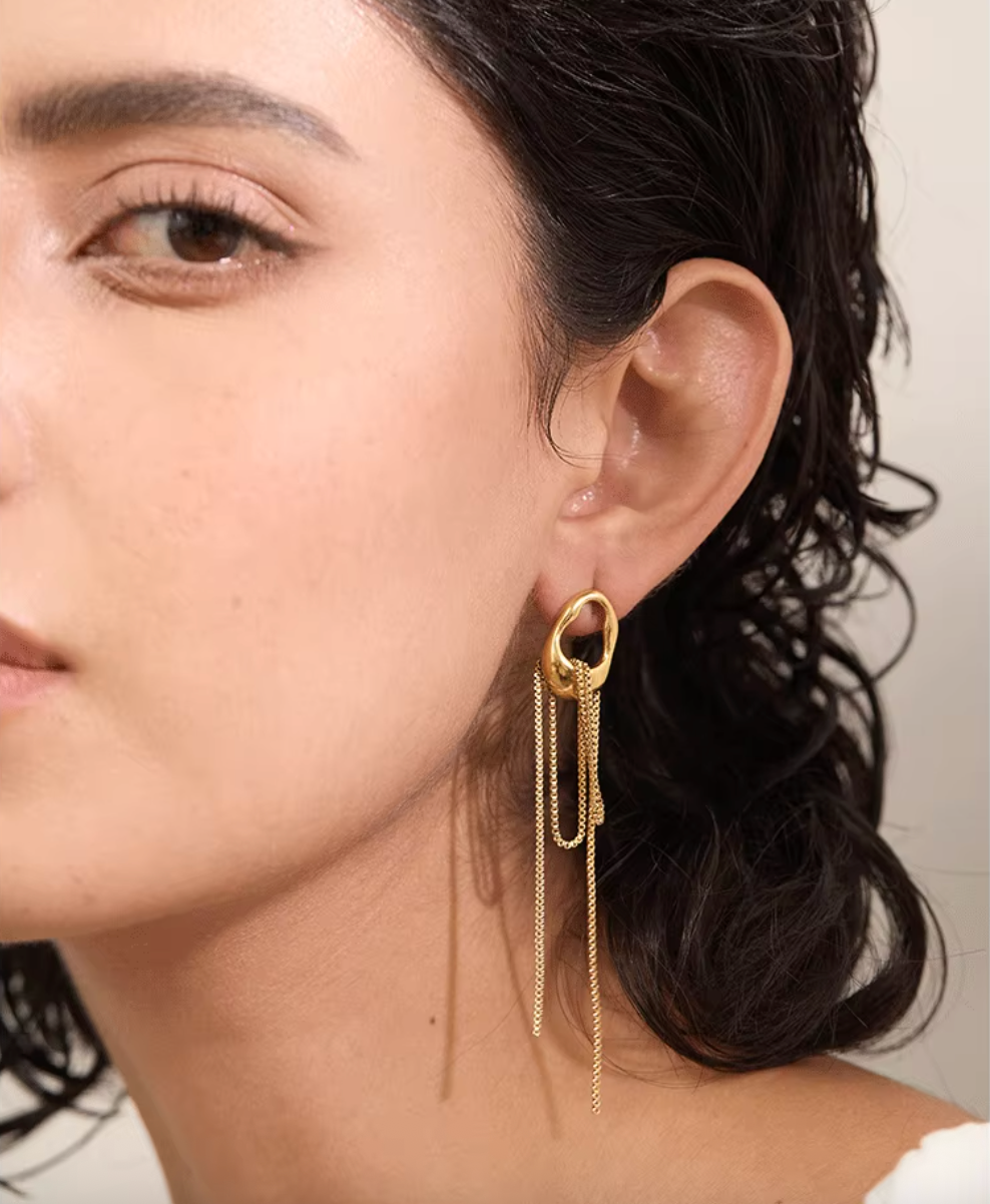 A pair of gold minimalist drop earrings with fine moving chain details