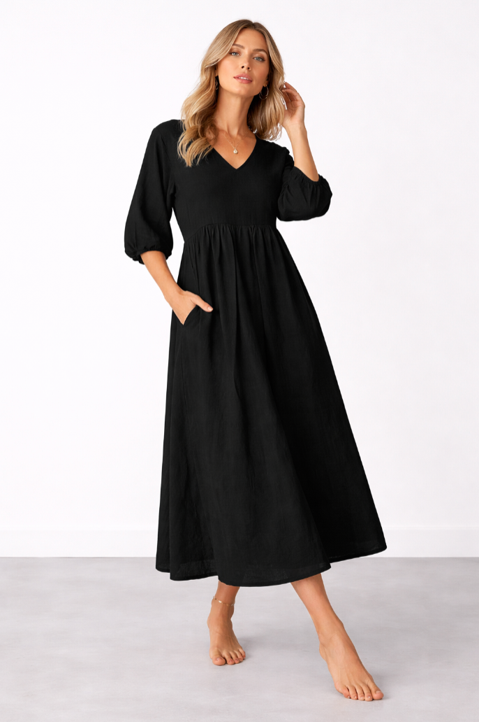 Floaty maxi dress in white, also available in black, with a soft V-neckline and side pockets