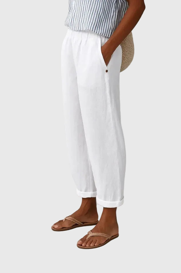 A woman wearing chic comfy trousers with a modern relaxed cut and flattering silhouette.