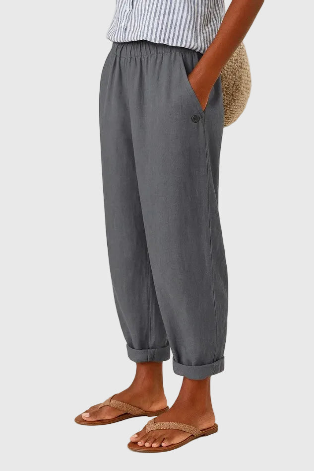 A woman wearing chic comfy trousers with a modern relaxed cut and flattering silhouette.