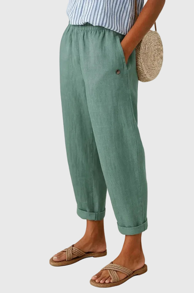 A woman wearing chic comfy trousers with a modern relaxed cut and flattering silhouette.