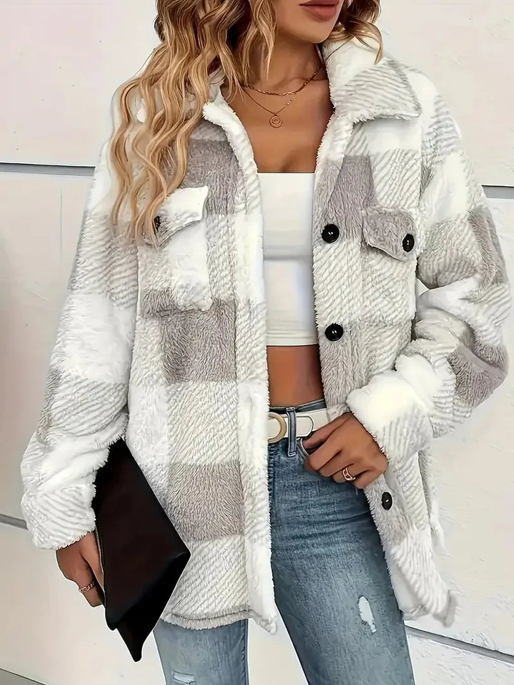 A woman wearing a soft checked jacket over casual clothes on a cool autumn morning.