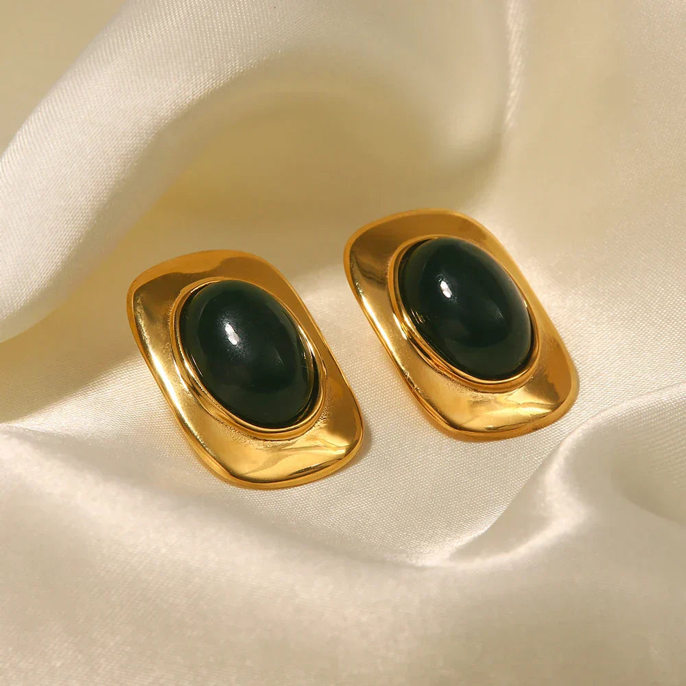 A pair of handcrafted oval drop earrings featuring a natural green opal stone with shifting colour