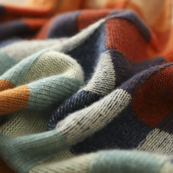 A woman wearing a colourful retro check jumper, relaxed and cosy on a cool autumn morning.