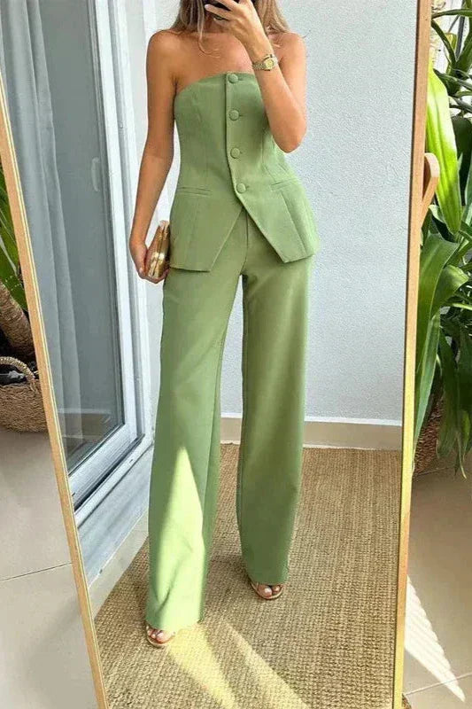 A woman wearing a tailored sleeveless button-detail top with matching wide-leg trousers.