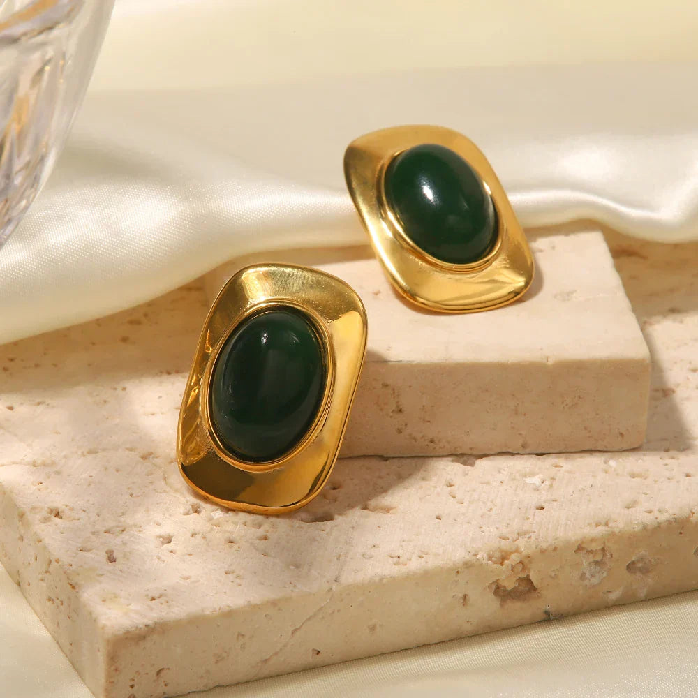 A pair of handcrafted oval drop earrings featuring a natural green opal stone with shifting colour
