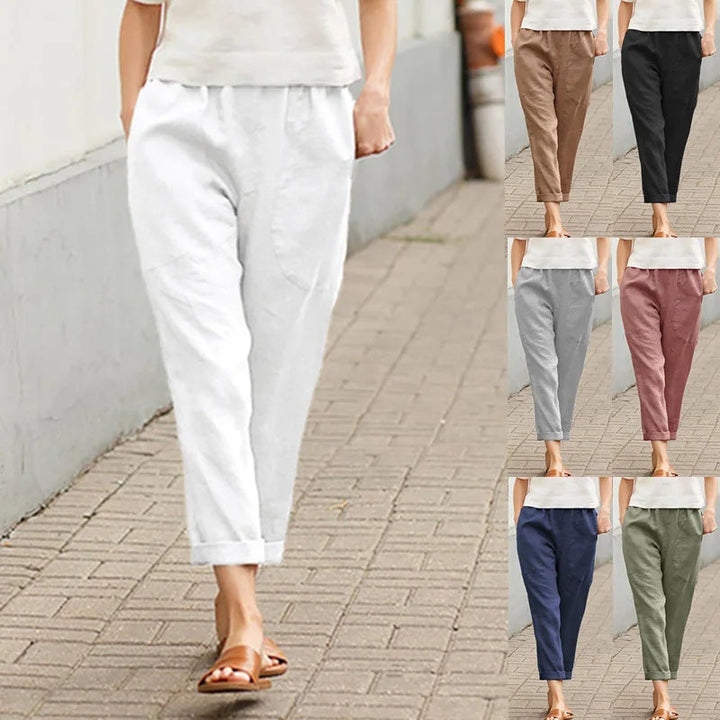 A woman wearing wide relaxed trousers with two roomy pockets and an elastic waist.