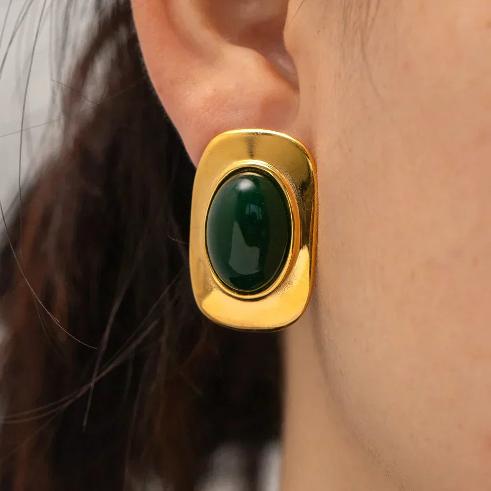 A pair of handcrafted oval drop earrings featuring a natural green opal stone with shifting colour