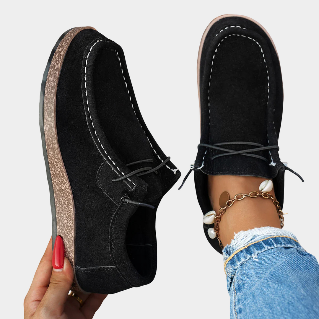 A woman wearing black boho-print lace-up comfort shoes while running errands.