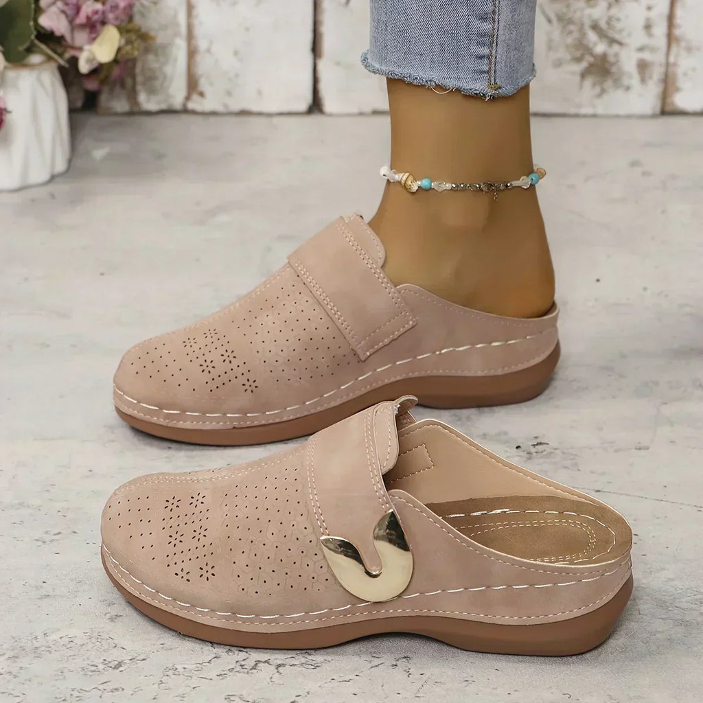 Black closed-toe clogs with decorative buckle detail