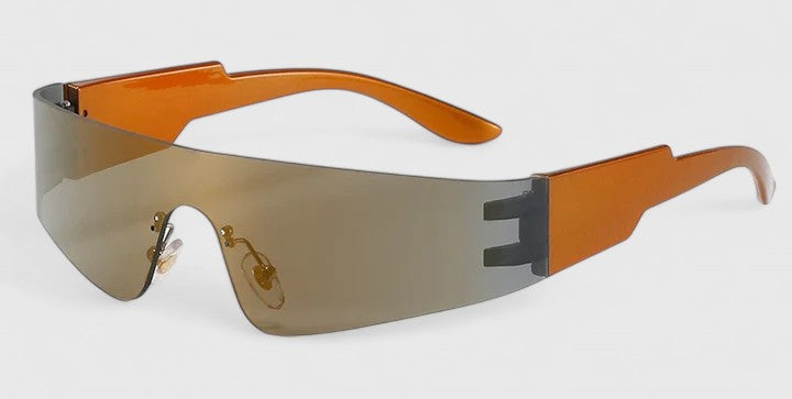 A woman strolling through town wearing sleek rimless sunglasses, looking modern and relaxed.