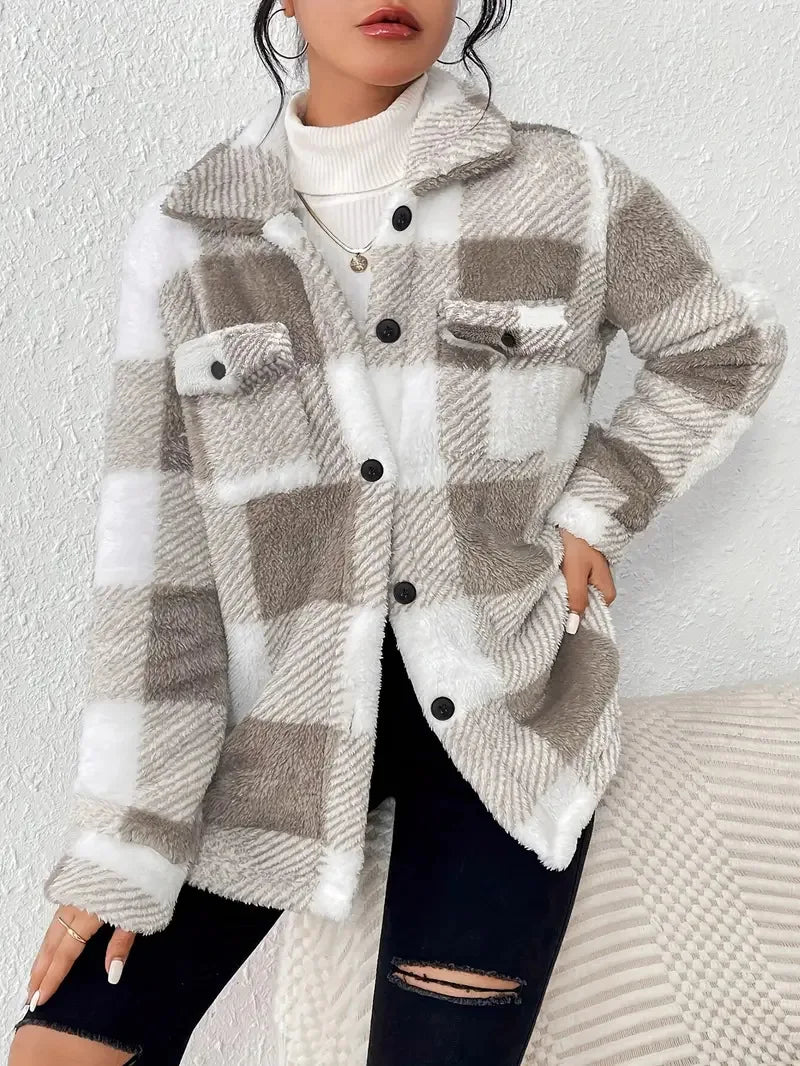 A woman wearing a soft checked jacket over casual clothes on a cool autumn morning.