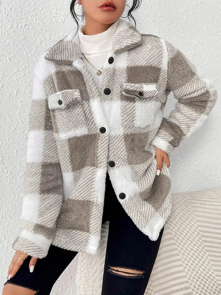 A woman wearing a soft checked jacket over casual clothes on a cool autumn morning.