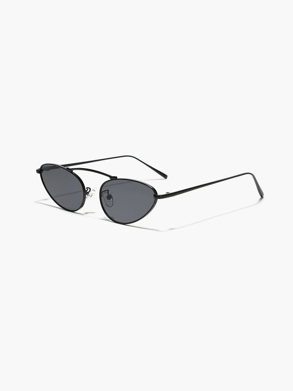 A woman wearing timeless slim black cat-eye sunglasses on an autumn day.