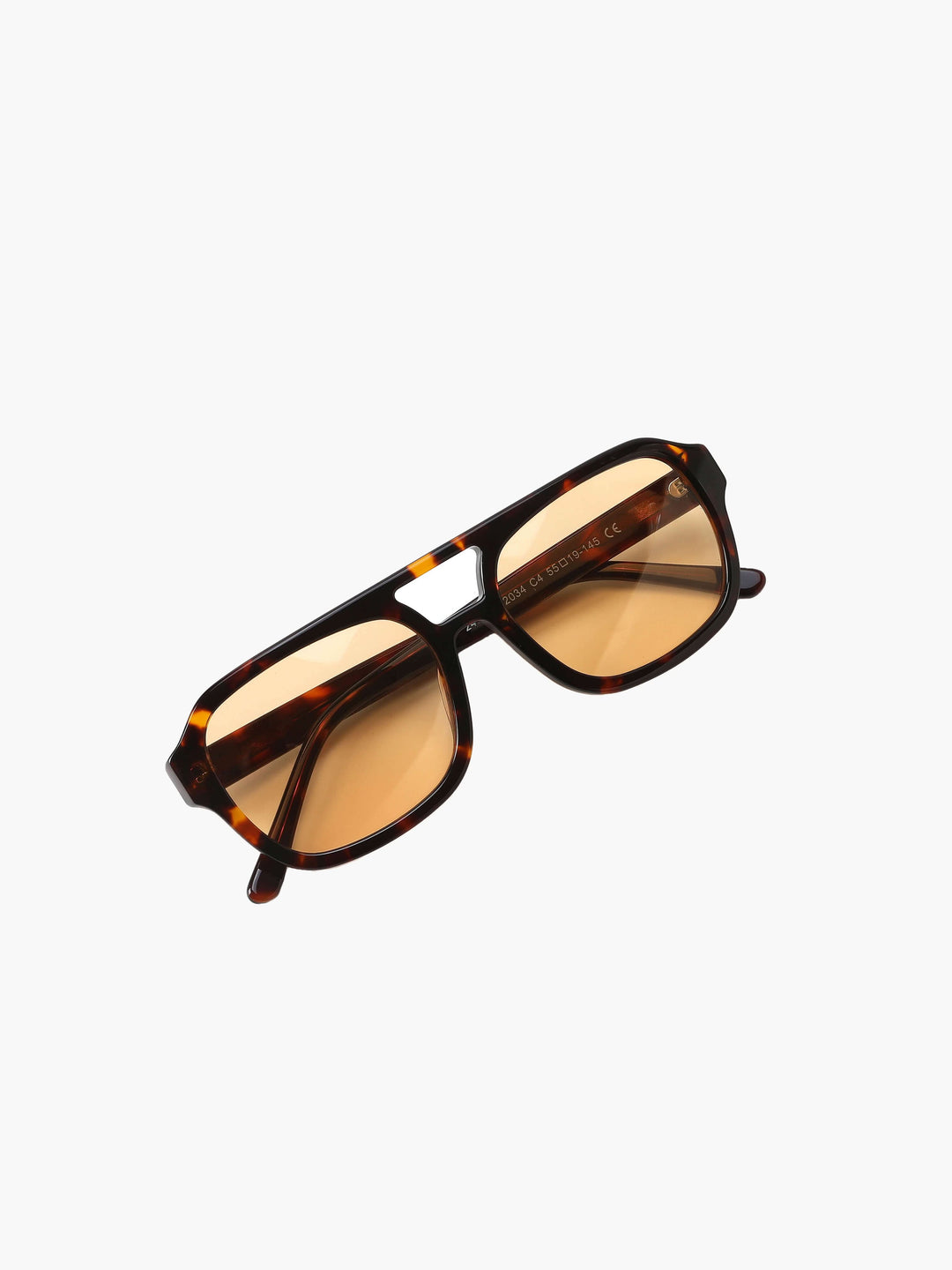 A woman wearing two-tone oval vintage sunglasses on a sunny day outdoors.