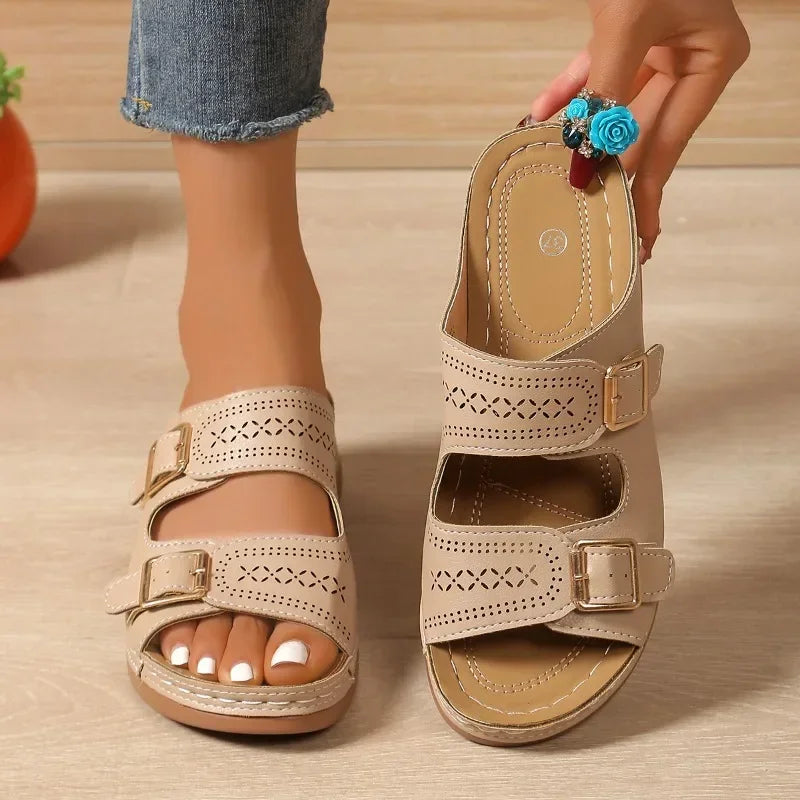 A woman walking with ease in wide-fit adjustable orthopaedic sandals with cushioned soles.