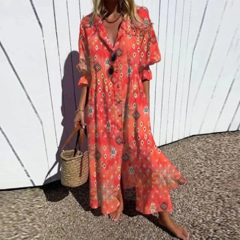 Woman wearing the Zara™ leaf print maxi dress with a button front, walking along the coast in a light breeze.
