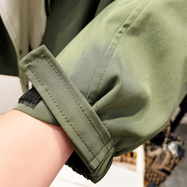 A woman wearing a lightweight weatherproof jacket with an adjustable hem on a blustery day.