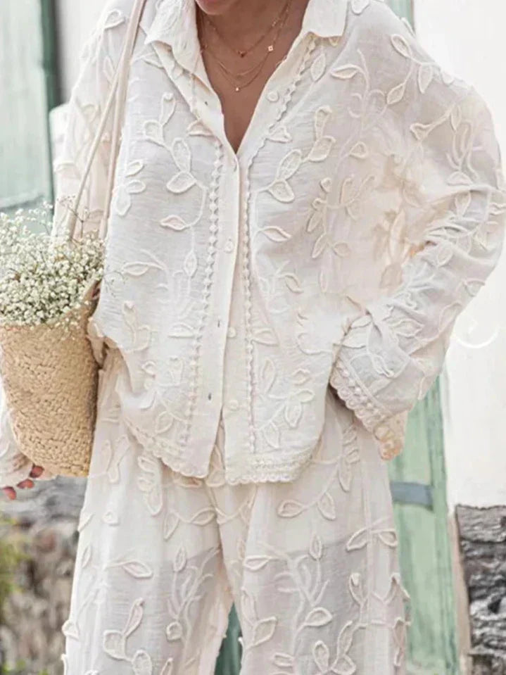 A woman wearing an embroidered relaxed two-piece set with wide trousers
