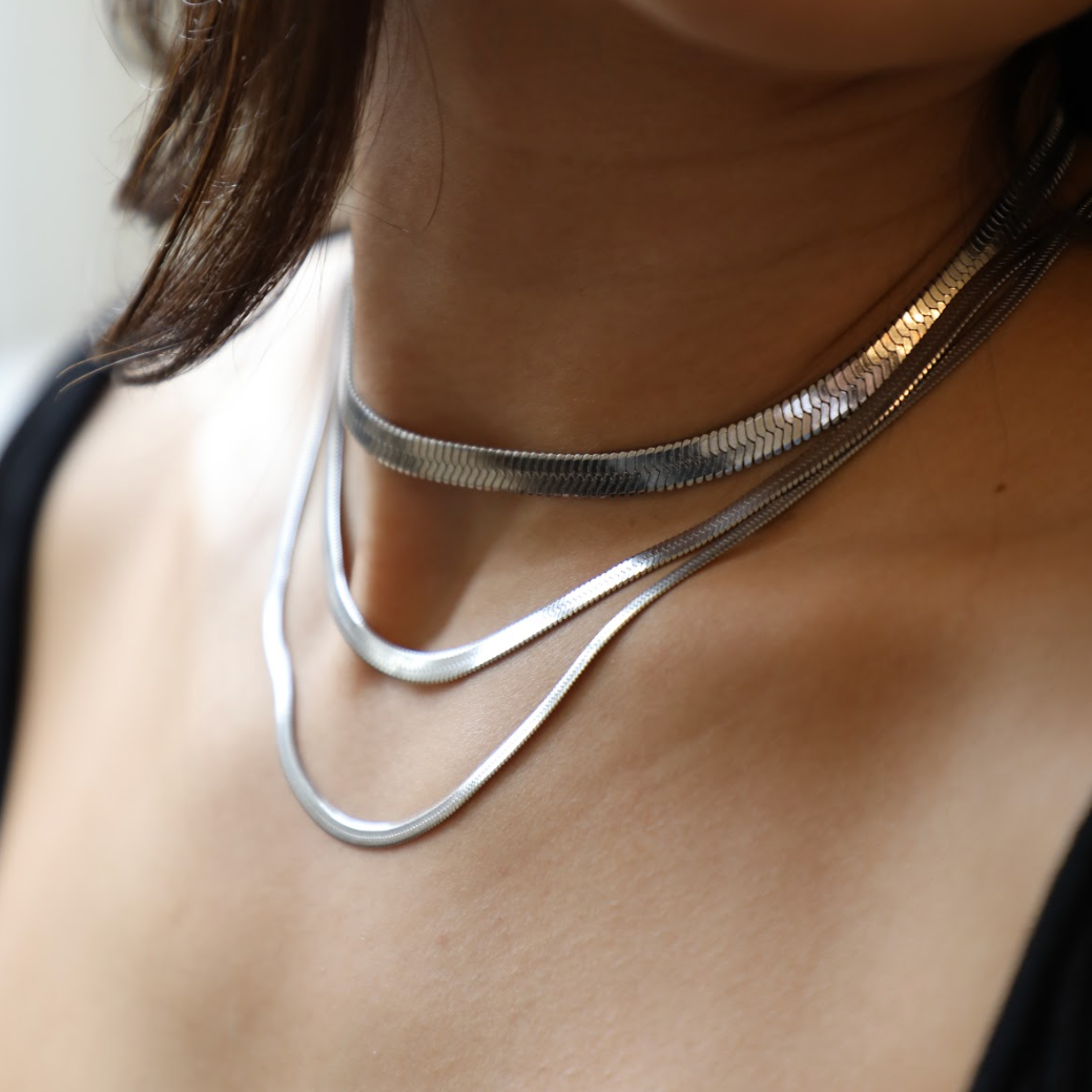 Gold snake pendant necklace with gleaming sculptural finish