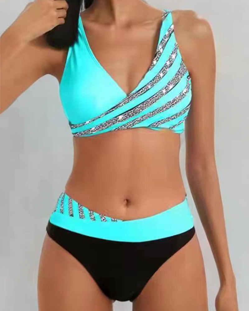 High-waist bikini with a baroque print in warm gold and jewel tones