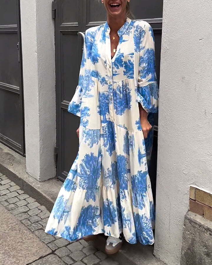 Woman wearing the Abigail flowing maxi dress with a delicate print and V-neckline, the skirt moving softly as she walks.